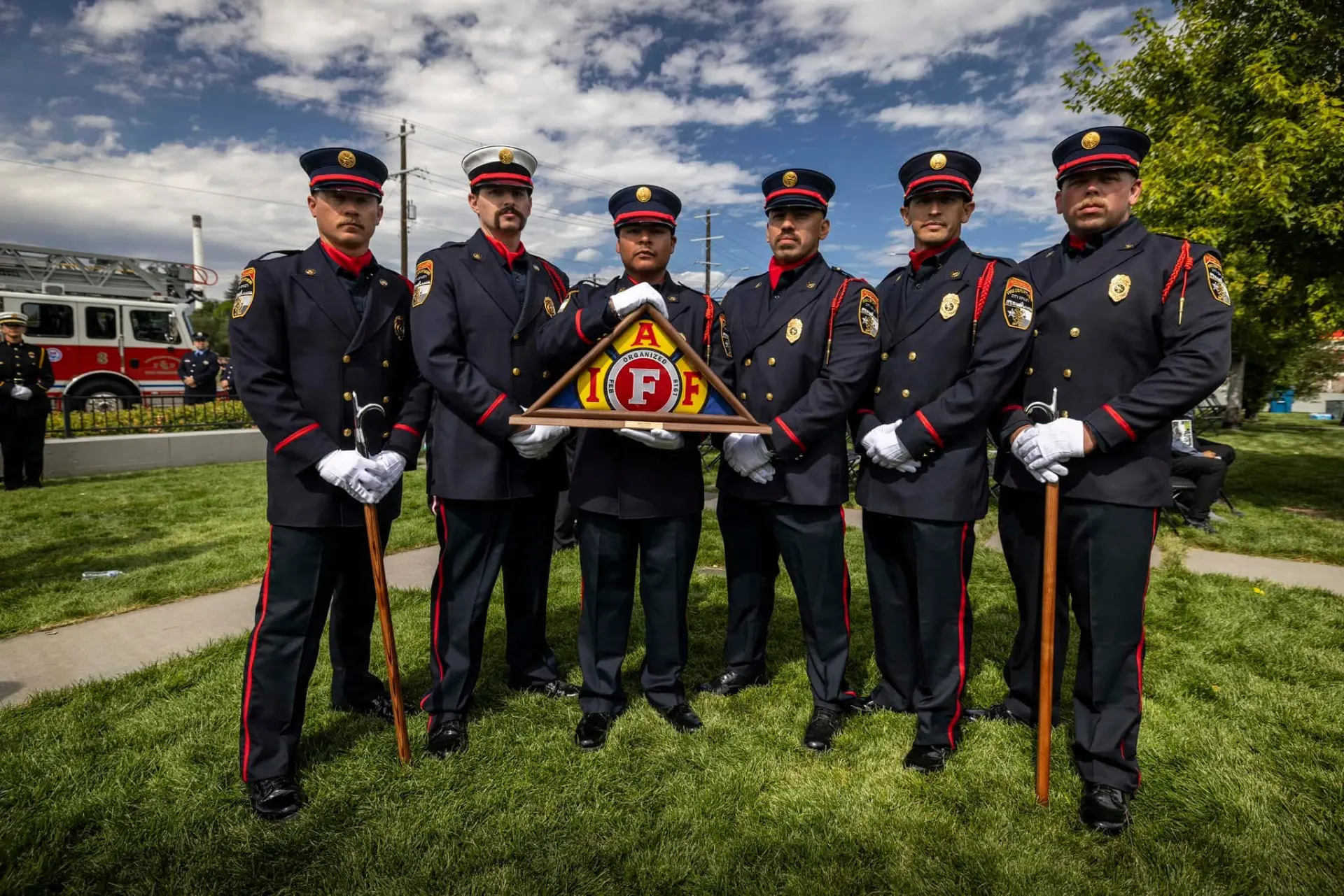 Six Katy Honor Guard members standing together with a folded-flag display at a remembrance ceremony